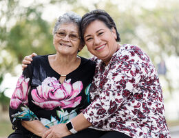 Two women share a hug and a smile.