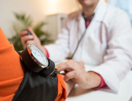 A provider checks a patient’s blood pressure.