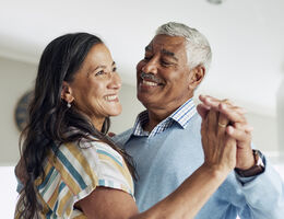 A dancing couple smiling.