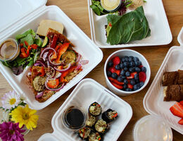 An array of open take-out containers viewed from above.