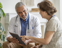 A woman talks to a doctor